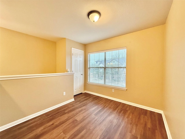 empty room with hardwood / wood-style flooring