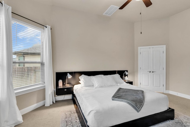 carpeted bedroom with a closet and ceiling fan