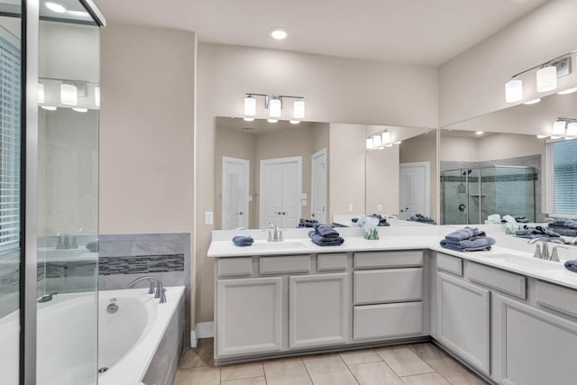 bathroom with tile patterned floors, vanity, and plus walk in shower