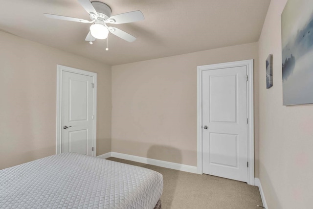 bedroom featuring a ceiling fan, light colored carpet, and baseboards