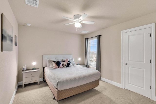 bedroom featuring baseboards, ceiling fan, visible vents, and light colored carpet