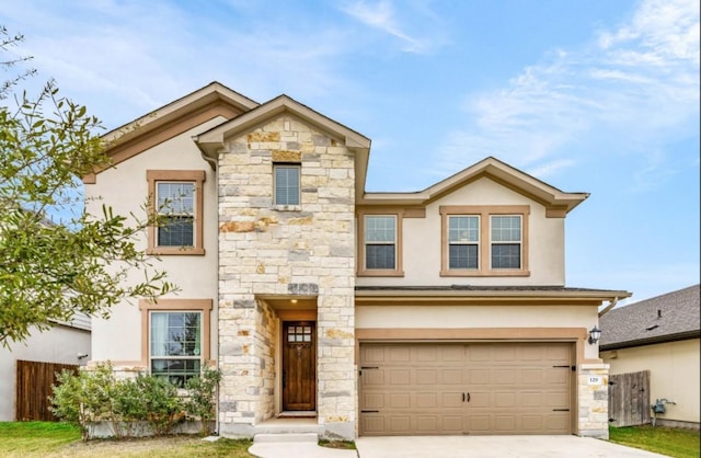 view of front of home with driveway, a garage, stone siding, fence, and stucco siding