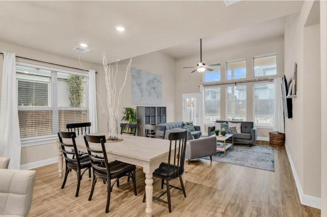 dining space featuring recessed lighting, plenty of natural light, light wood-style flooring, and baseboards