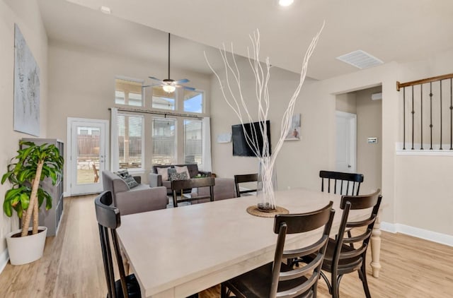 dining area with ceiling fan and light hardwood / wood-style flooring