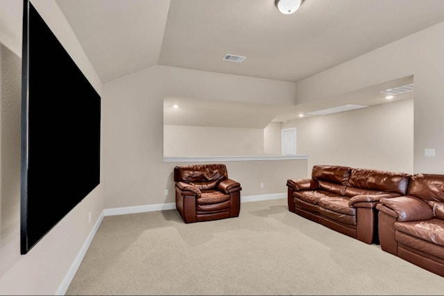 home theater with lofted ceiling and light colored carpet