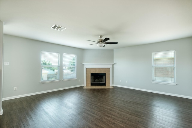 unfurnished living room with dark hardwood / wood-style flooring, a fireplace, and ceiling fan