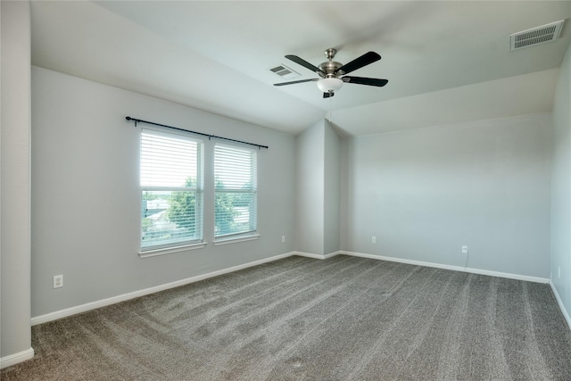 carpeted empty room featuring vaulted ceiling and ceiling fan