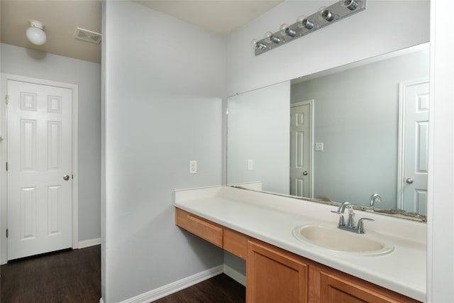 bathroom with vanity and wood-type flooring