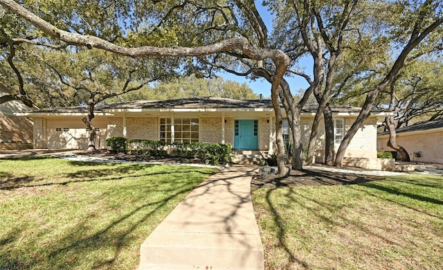 single story home featuring a garage and a front yard