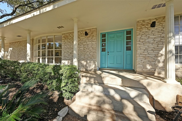 view of exterior entry with covered porch