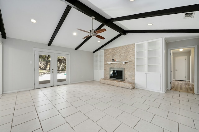 unfurnished living room featuring a fireplace, lofted ceiling with beams, french doors, and light tile patterned flooring