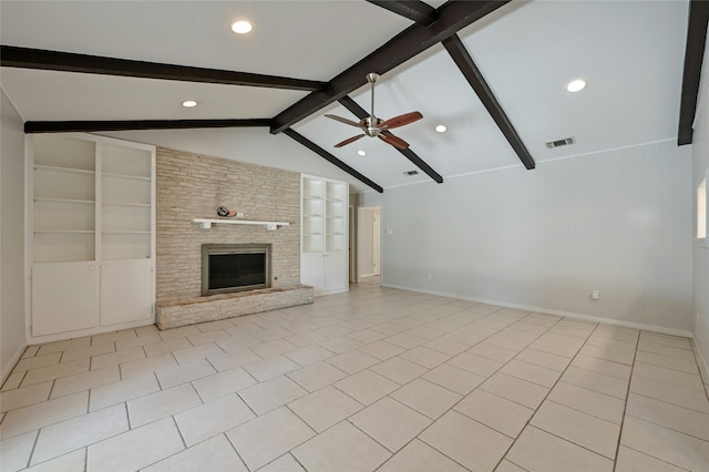 unfurnished living room featuring light tile patterned floors, ceiling fan, vaulted ceiling with beams, a fireplace, and built in shelves