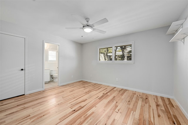 unfurnished bedroom featuring ceiling fan, ensuite bath, and light hardwood / wood-style flooring