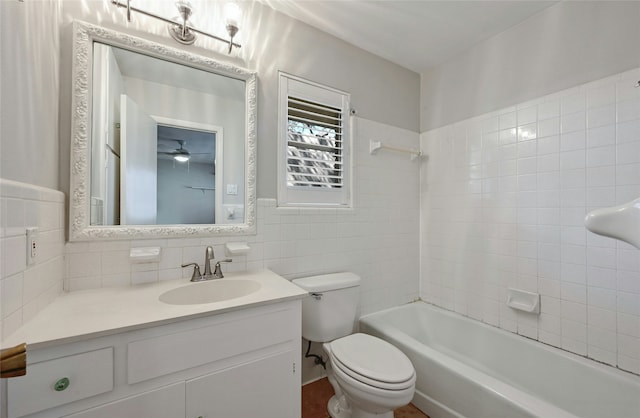 full bathroom with tile walls, backsplash, tiled shower / bath combo, vanity, and toilet