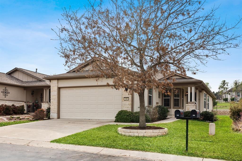 view of front of home with a garage and a front lawn