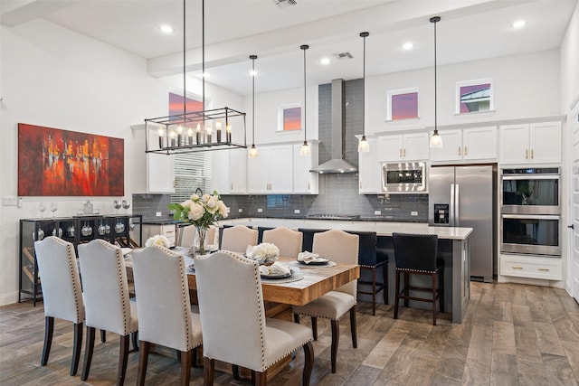 dining area featuring dark hardwood / wood-style flooring and a towering ceiling