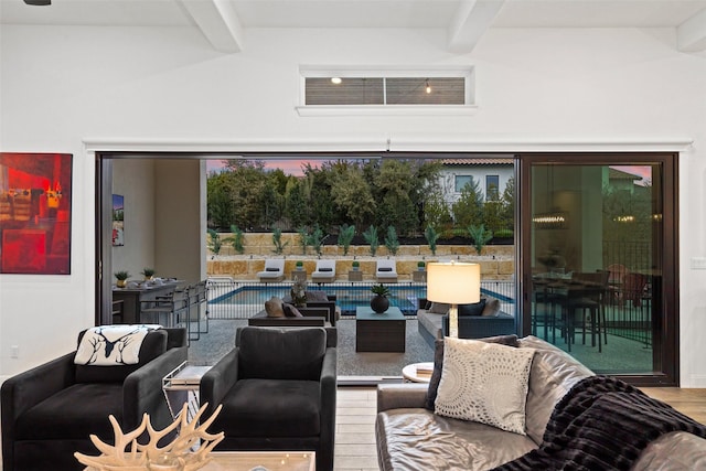 living room featuring wood-type flooring and beam ceiling