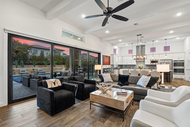 living room featuring beamed ceiling, ceiling fan, and hardwood / wood-style flooring