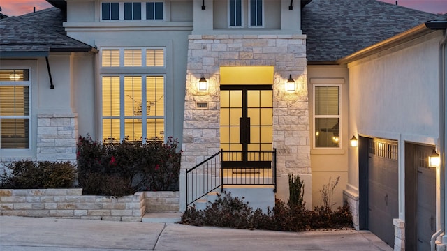 view of exterior entry at dusk