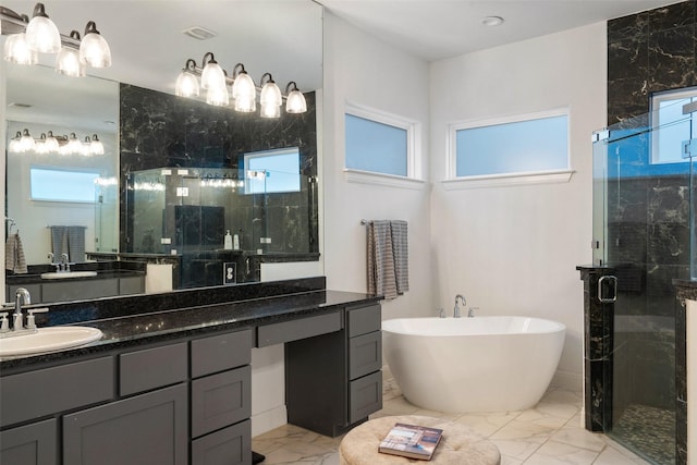 bathroom featuring vanity and shower with separate bathtub