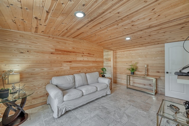 living room featuring lofted ceiling, wooden ceiling, and wood walls