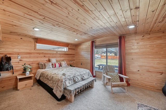 carpeted bedroom featuring wood walls, access to outside, and wooden ceiling