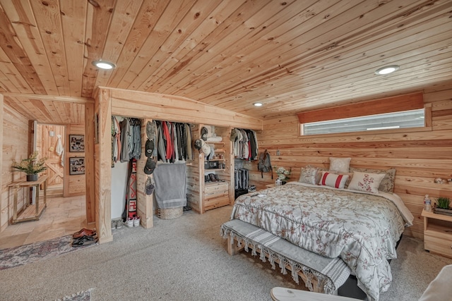 carpeted bedroom featuring wood ceiling, a closet, and wood walls