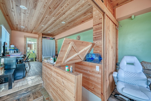 interior space with wood ceiling and wood walls