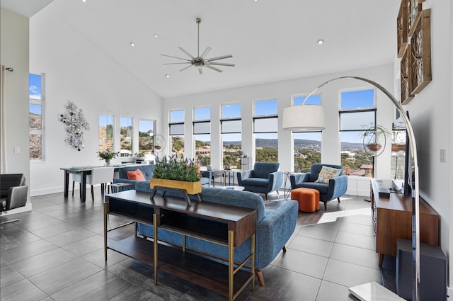 living room featuring ceiling fan and a high ceiling