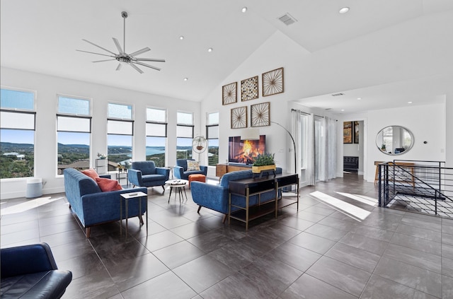 living room featuring ceiling fan, a mountain view, and high vaulted ceiling