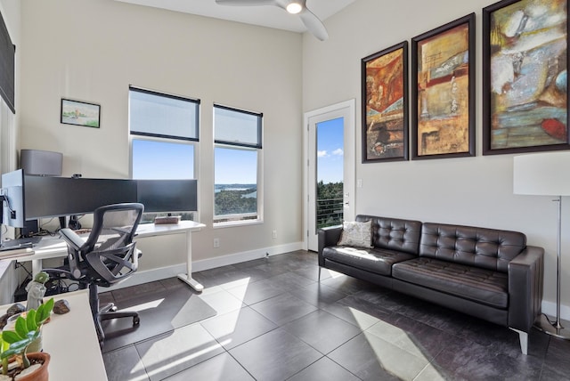 home office with ceiling fan and tile patterned floors