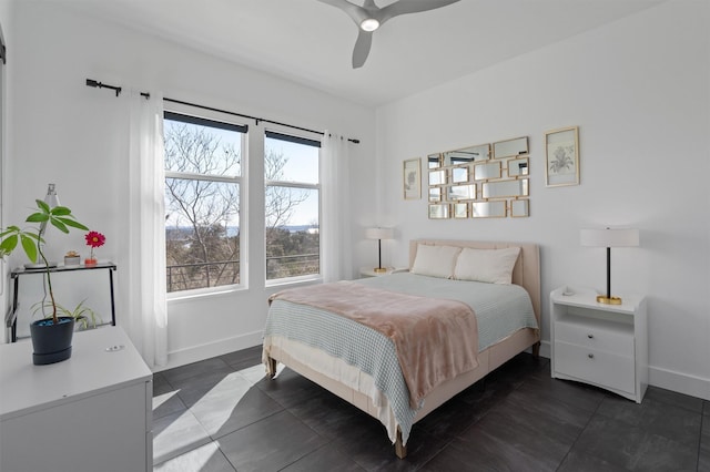 tiled bedroom featuring ceiling fan