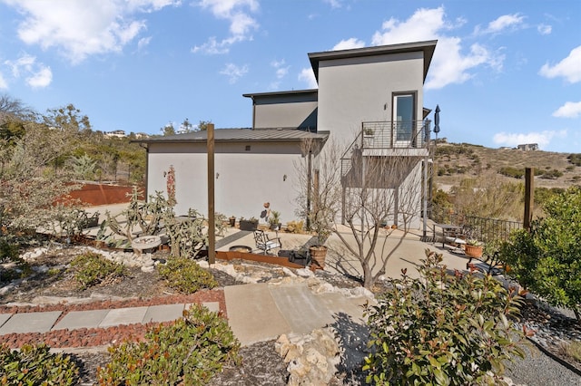 back of house with a patio area and a balcony