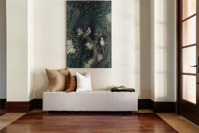 sitting room featuring baseboards and wood finished floors