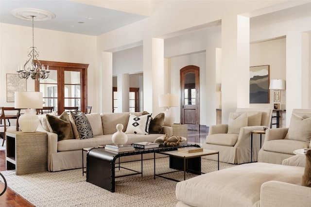 living area with a chandelier and wood finished floors