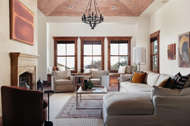 living room featuring brick ceiling, a fireplace, and a notable chandelier