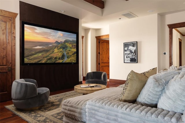 home theater room featuring wood finished floors and visible vents