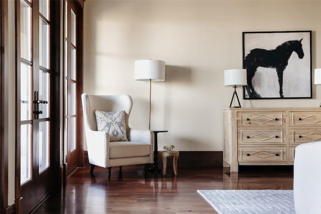 sitting room featuring dark wood-style flooring