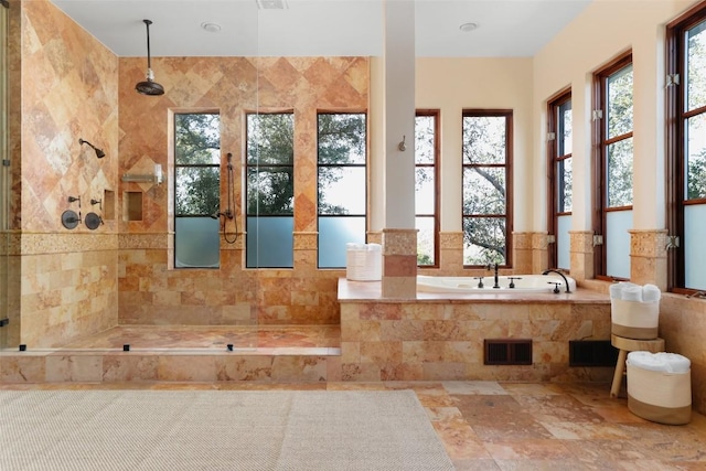 full bath with a garden tub, visible vents, and a tile shower