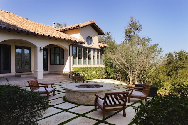 view of patio / terrace with an outdoor fire pit and french doors