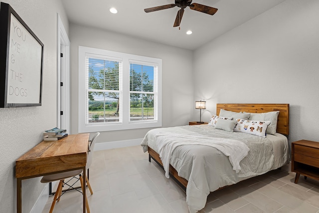 tiled bedroom featuring ceiling fan