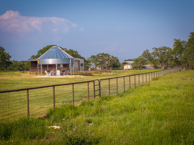 view of yard featuring an outbuilding and a rural view