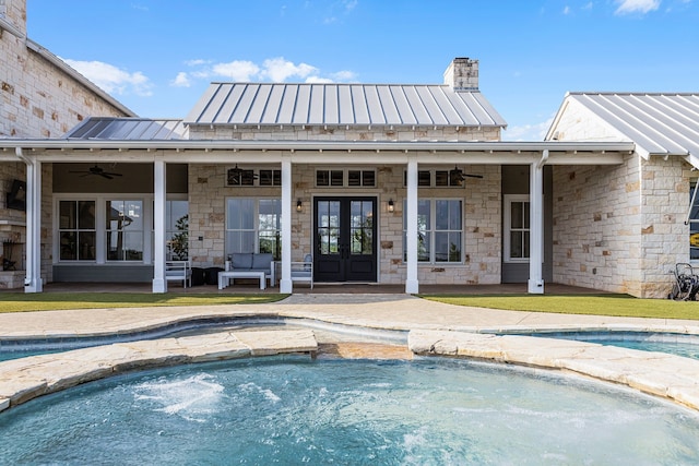 view of pool featuring french doors, ceiling fan, a hot tub, and a patio area