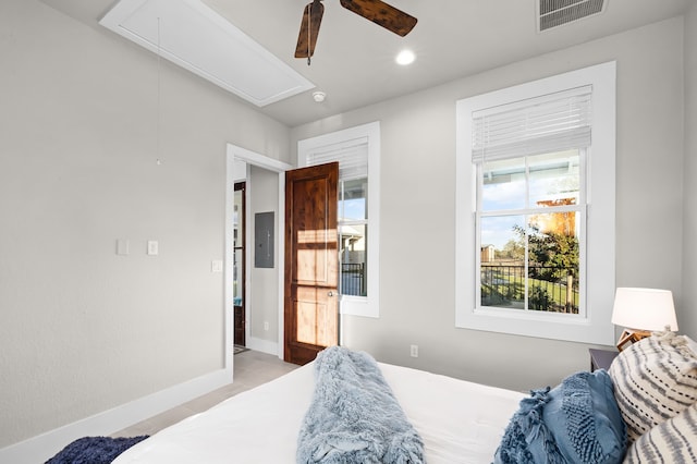 tiled bedroom featuring ceiling fan and electric panel