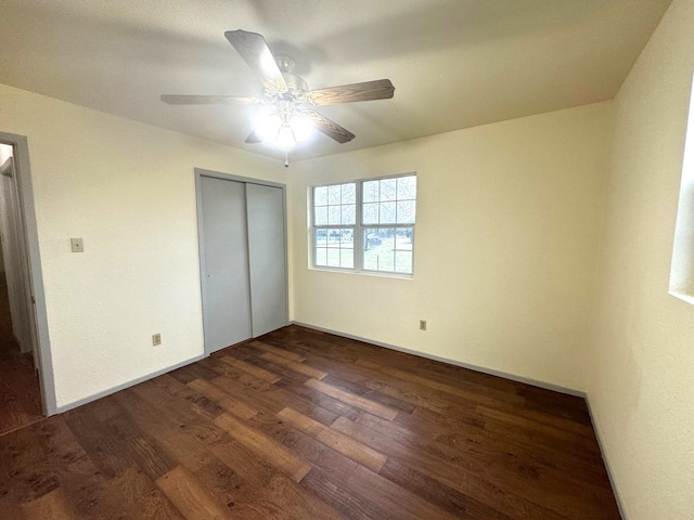 unfurnished bedroom featuring ceiling fan, dark hardwood / wood-style flooring, and a closet