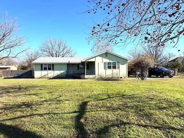 back of house with a lawn and fence