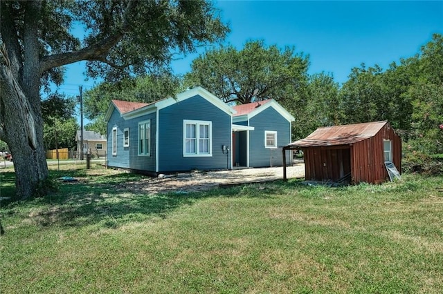 back of house with a lawn