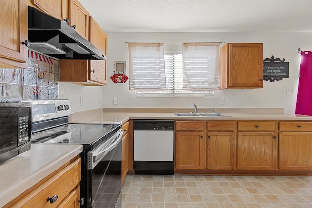 kitchen featuring dishwasher, sink, a textured ceiling, and stainless steel electric range