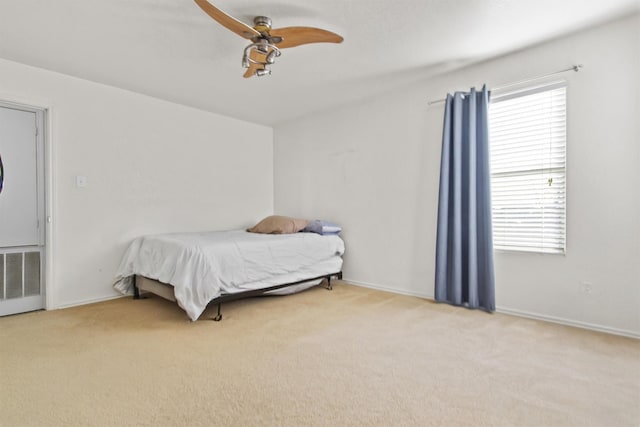 bedroom featuring light colored carpet and ceiling fan