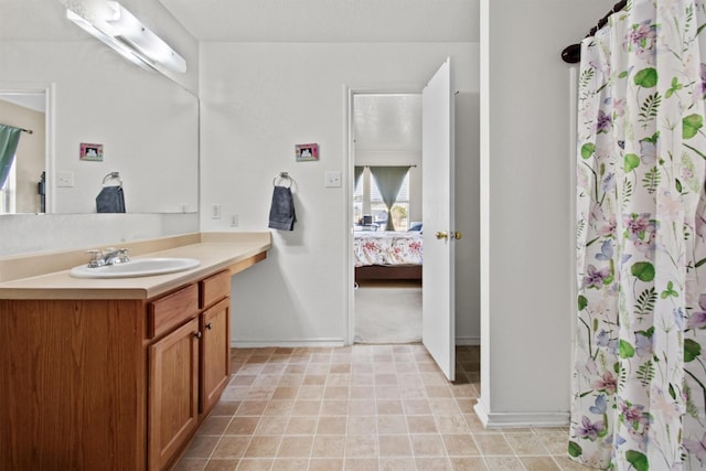 bathroom featuring walk in shower and vanity